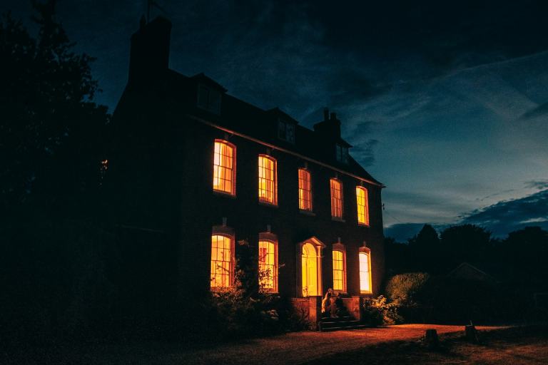 Brick Federal-style home glowing at blue hour, the kind of Middle Tennessee purchase where a closing attorney earns the fee